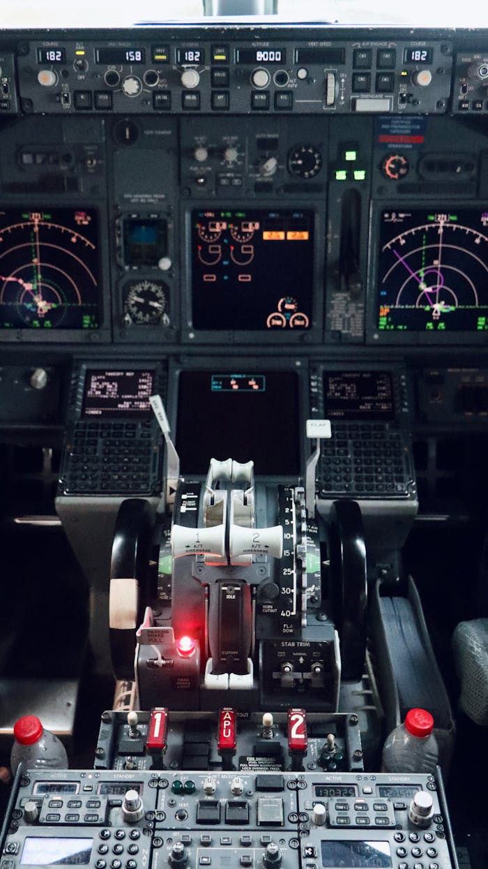 Detailed view of an aircraft cockpit with control panels and instruments.